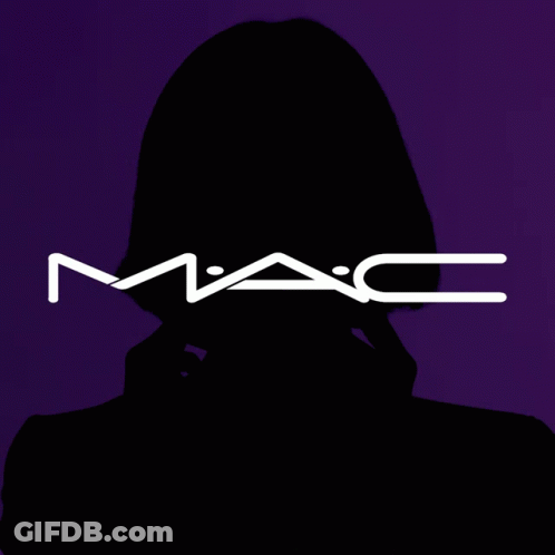 A Woman Covering Her Face With A Mac Logo Behind Her GIF