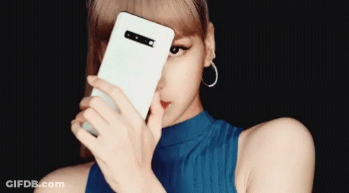 A Woman Covering Her Face With A White Phone GIF