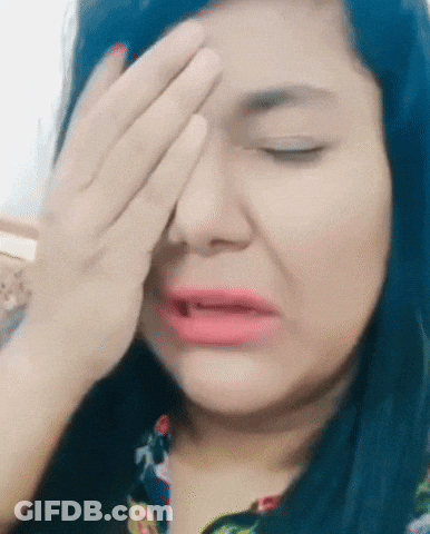 A Woman Covering Her Face With Her Hand And Making A Funny Face GIF