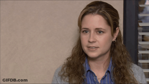 A Woman Covering Her Face With Her Hand While Looking Down GIF