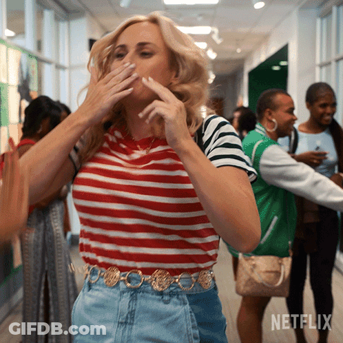 A Woman Covering Her Mouth In A Hallway With Netflix Written On The Bottom GIF