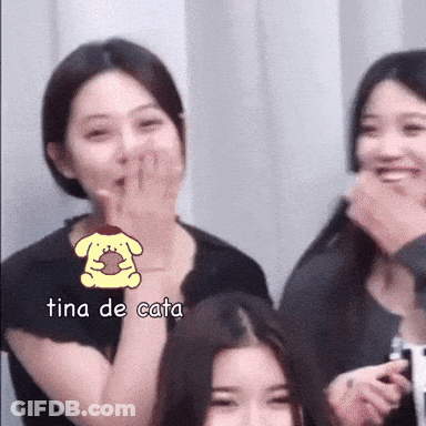 A Woman Covering Her Mouth With Her Hand And The Word Tina De Cata Is On The Bottom GIF