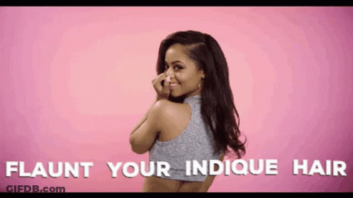 A Woman Covering Her Nose With Her Hand With The Words Flaunt Your Indicque Hair Written Below Her GIF