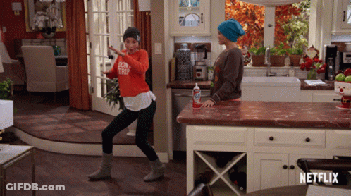 Woman Dancing In Kitchen With Netflix Logo GIF