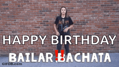 A Woman Dancing In Front Of A Brick Wall That Says Happy Birthday GIF