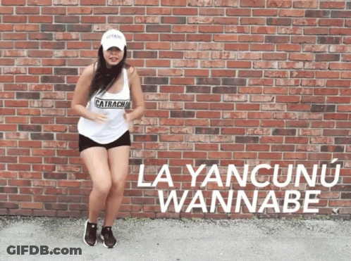 A Woman Dancing In Front Of A Brick Wall That Says La Yancunu Wannabe On It GIF