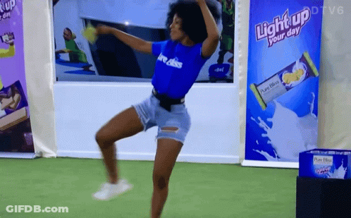 A Woman Dancing In Front Of A Light Up Your Day Advertisement GIF