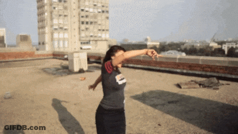 A Woman Dancing On A Rooftop Wearing A Shirt That Says ' Chicago ' On It GIF
