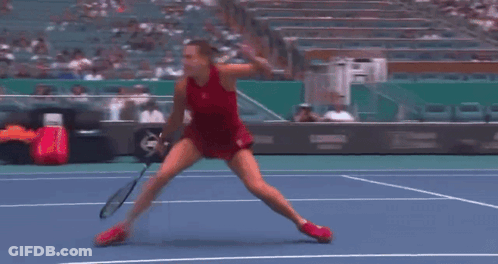A Woman Doing A Split On A Tennis Court In Front Of A Pnc Bank Sign GIF