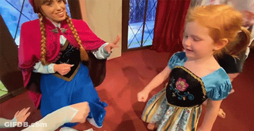 A Woman Dressed As Anna And A Little Girl Dressed As Elsa Are Dancing Together . GIF