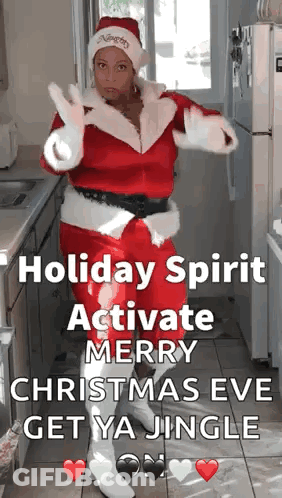 A Woman Dressed As Santa Claus Is Dancing In A Kitchen GIF