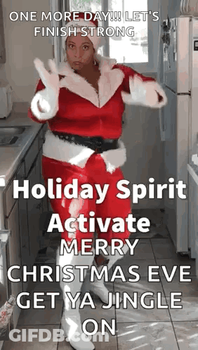 A Woman Dressed As Santa Claus Is Dancing In A Kitchen With A Christmas Message . GIF