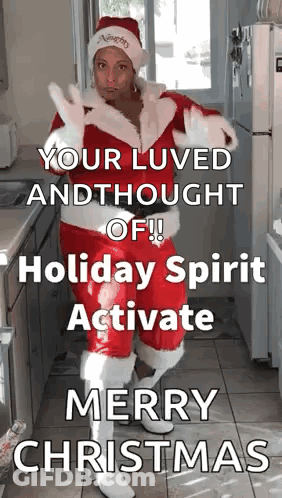A Woman Dressed As Santa Claus Is Standing In A Kitchen With A Christmas Message GIF
