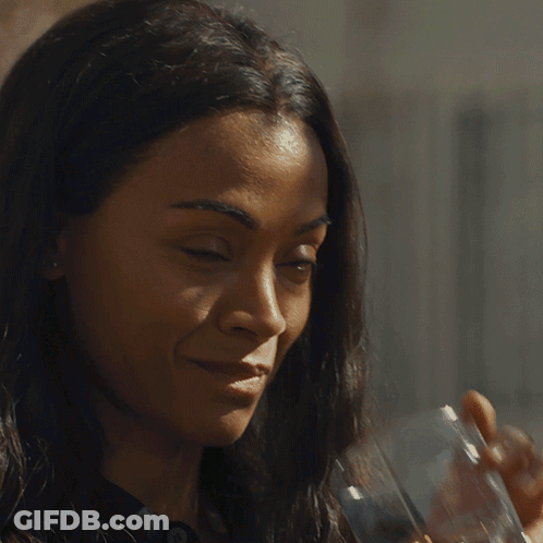 A Woman Drinking A Glass Of Whiskey With A Watch On Her Wrist GIF