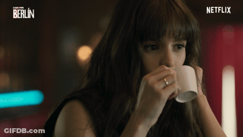 A Woman Drinking From A Cup With A Netflix Logo In The Corner GIF