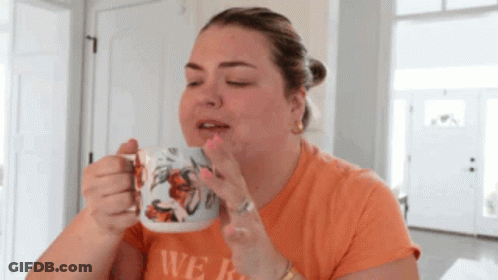 A Woman Drinking From A Mug That Says We GIF