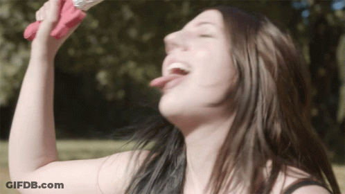 A Woman Drinking From A Pink Bottle With Her Tongue Sticking Out GIF