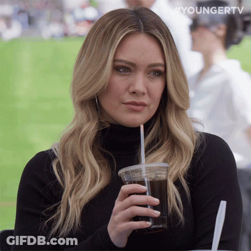 A Woman Drinking From A Plastic Cup With A Straw And The Words Youngertv On The Bottom GIF
