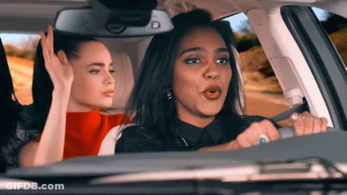 A Woman Driving A Car With Two Other Women GIF