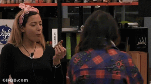 Woman Eating Food In Front Of L'isola Sign GIF