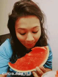 A Woman Eating A Slice Of Watermelon Wearing A Shirt That Says App GIF