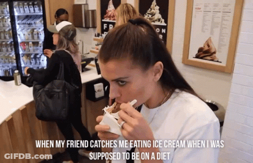 A Woman Eating Ice Cream In Front Of A Sign That Says Fr GIF