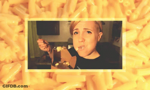 A Woman Eating Macaroni And Cheese With A Fork GIF