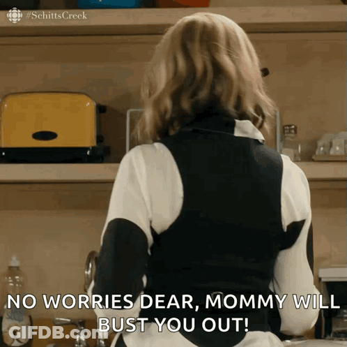 A Woman From Schitts Creek Is Standing In Front Of A Yellow Toaster GIF