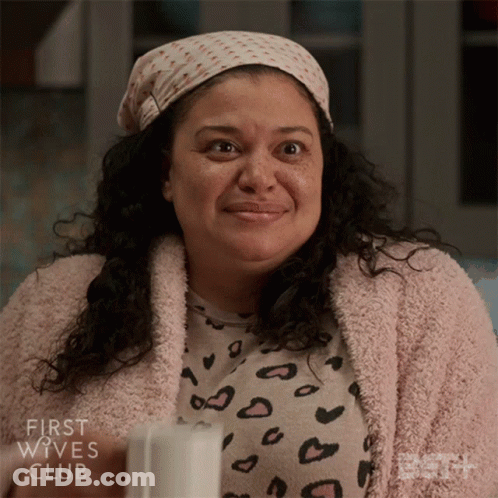 A Woman From The First Wives Club Is Smiling And Wearing A Leopard Print Shirt GIF