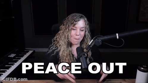 A Woman Giving A Peace Sign In Front Of A Microphone With The Words Peace Out Written Below Her GIF