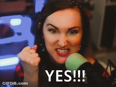 A Woman Giving A Thumbs Up In Front Of A Green Microphone With The Word Yes Written On The Screen GIF