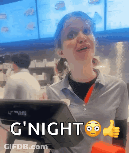 A Woman Giving A Thumbs Up Next To A Sign That Says G Night GIF