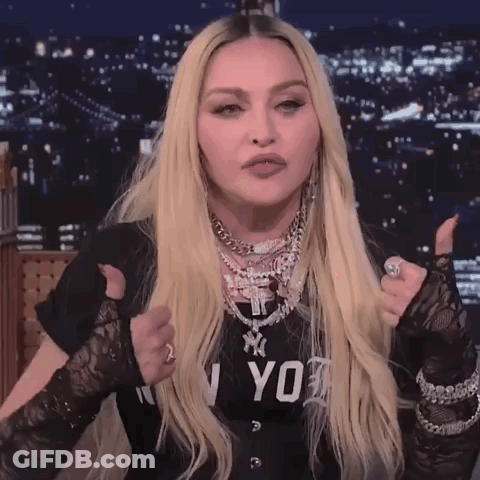 A Woman Giving A Thumbs Up Wearing A Black Shirt That Says Ny On It GIF