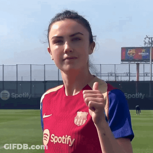 A Woman Giving A Thumbs Up Wearing A Spotify Shirt GIF