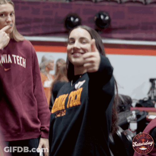 A Woman Giving A Thumbs Up Wearing A Sweater That Says Nia Tech GIF