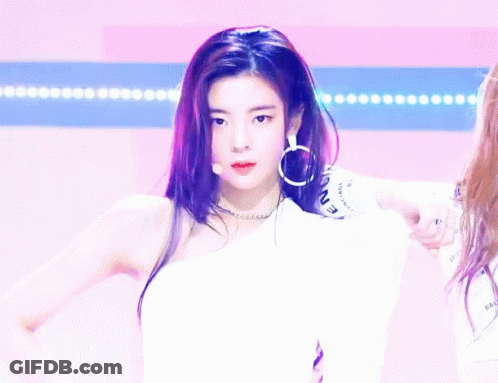 A Woman Giving A Thumbs Up While Wearing A White Shirt That Says Icon GIF