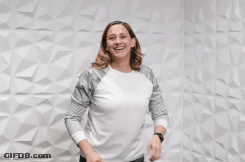 A Woman Giving A Thumbs Up With The Words " You 'Re Awesome " Behind Her GIF