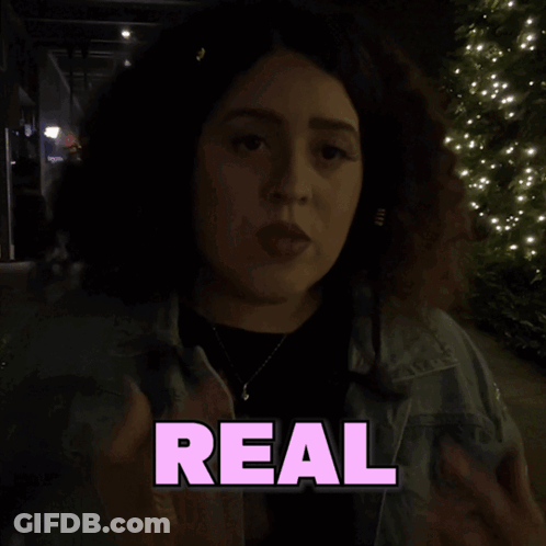 A Woman Giving The Middle Finger In Front Of A Sign That Says Like Shagarita GIF