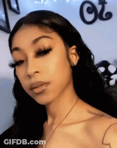 A Woman Has A Tattoo On Her Shoulder That Says " Courage " GIF