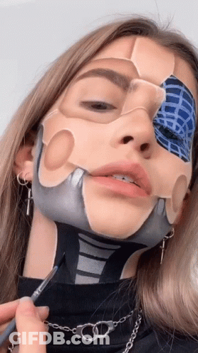 A Woman Has Her Face Painted In The Shape Of A Skeleton GIF