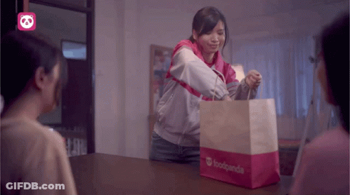 A Woman Holding A Bag That Says Foodpanda GIF
