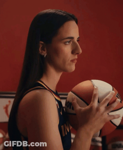 A Woman Holding A Basketball That Says Molten GIF
