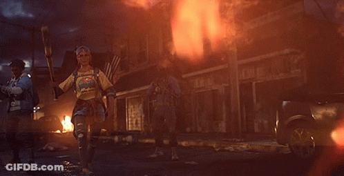 A Woman Holding A Bat And Wearing A T-Shirt That Says ' I 'M A Hippie ' GIF