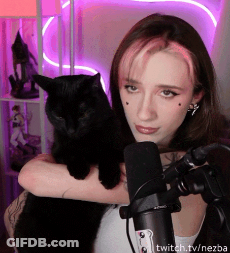 A Woman Holding A Black Cat In Front Of A Microphone With Twitch.tv/nezba On The Bottom Right GIF