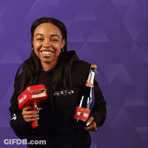 A Woman Holding A Bottle And A Box That Says Money Gun GIF