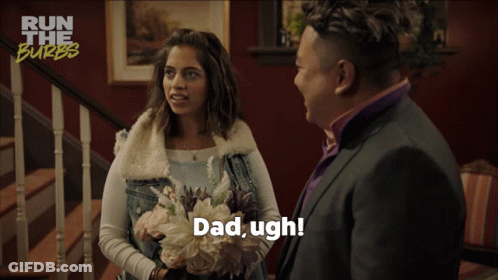 A Woman Holding A Bouquet Of Flowers Is Talking To A Man In A Suit Who Says Dad Ugh GIF