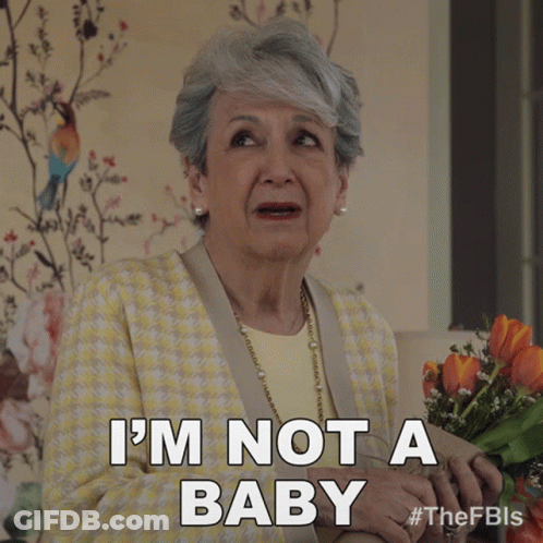 A Woman Holding A Bouquet Of Flowers Says " I 'M Not A Baby " GIF