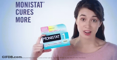A Woman Holding A Box Of Monistat Pills GIF