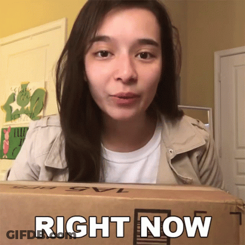 A Woman Holding A Box That Says Right Now On It GIF