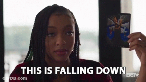 A Woman Holding A Card That Says This Is Falling Down GIF